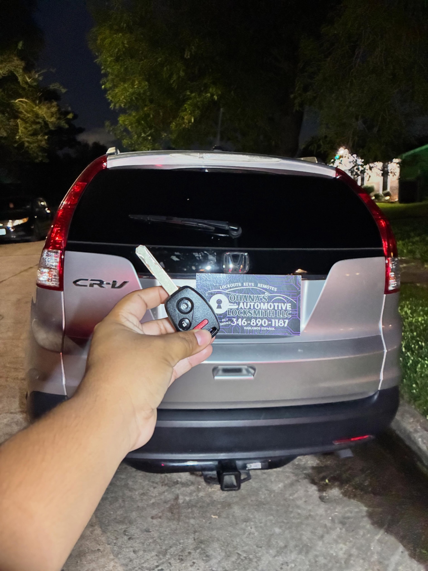 Locksmith technician cutting a car key on-site in Houston